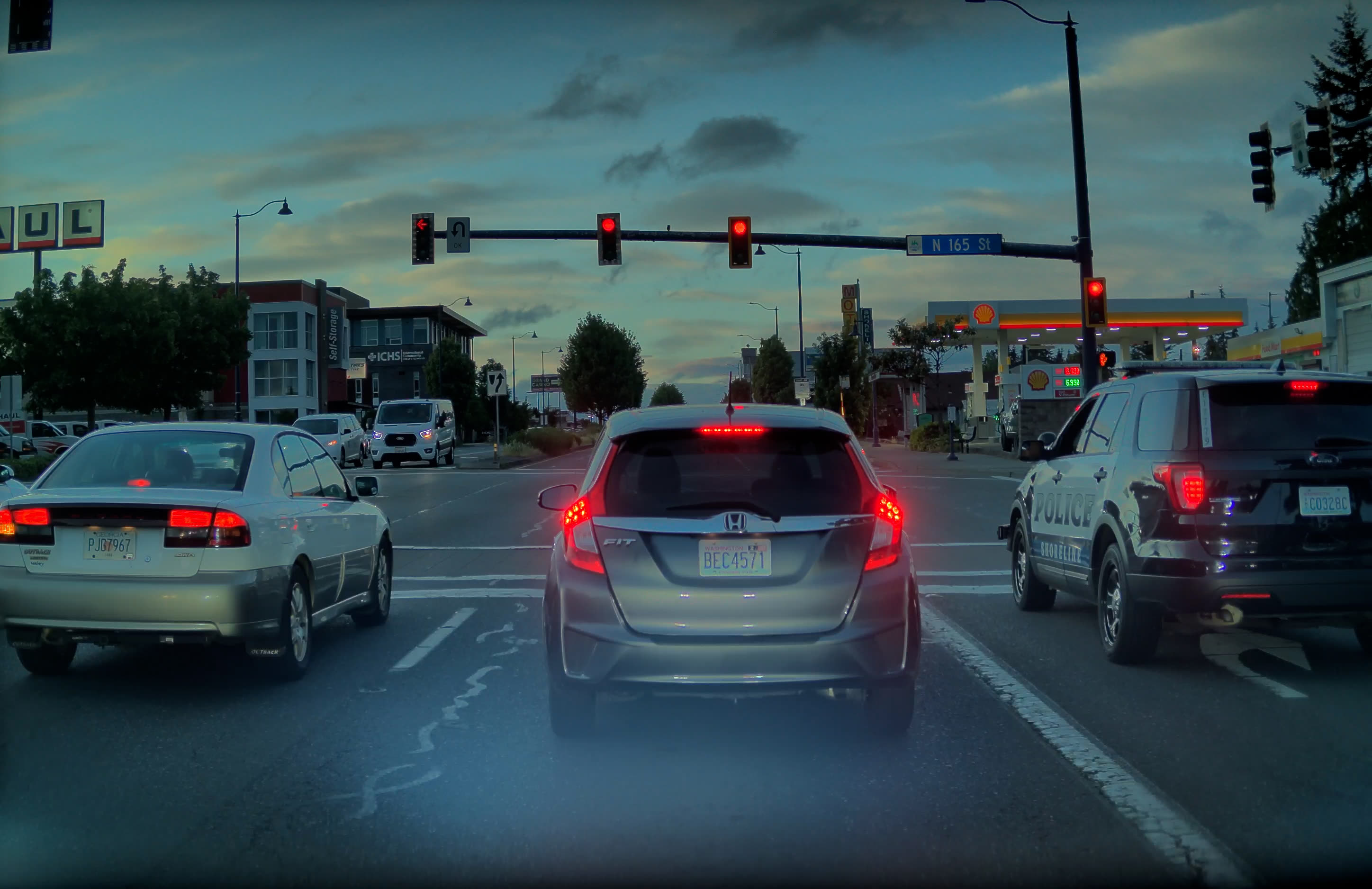 Marked police vehicle in the right-turn-only lane at N 165th St